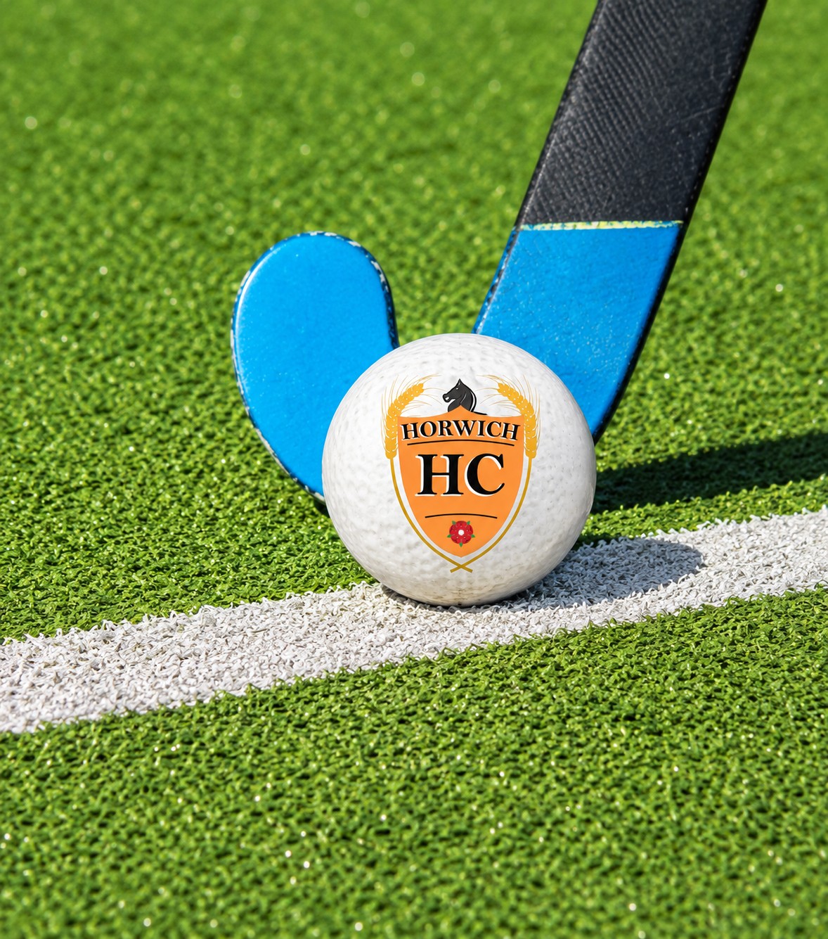Hockey stick and ball on the pitch