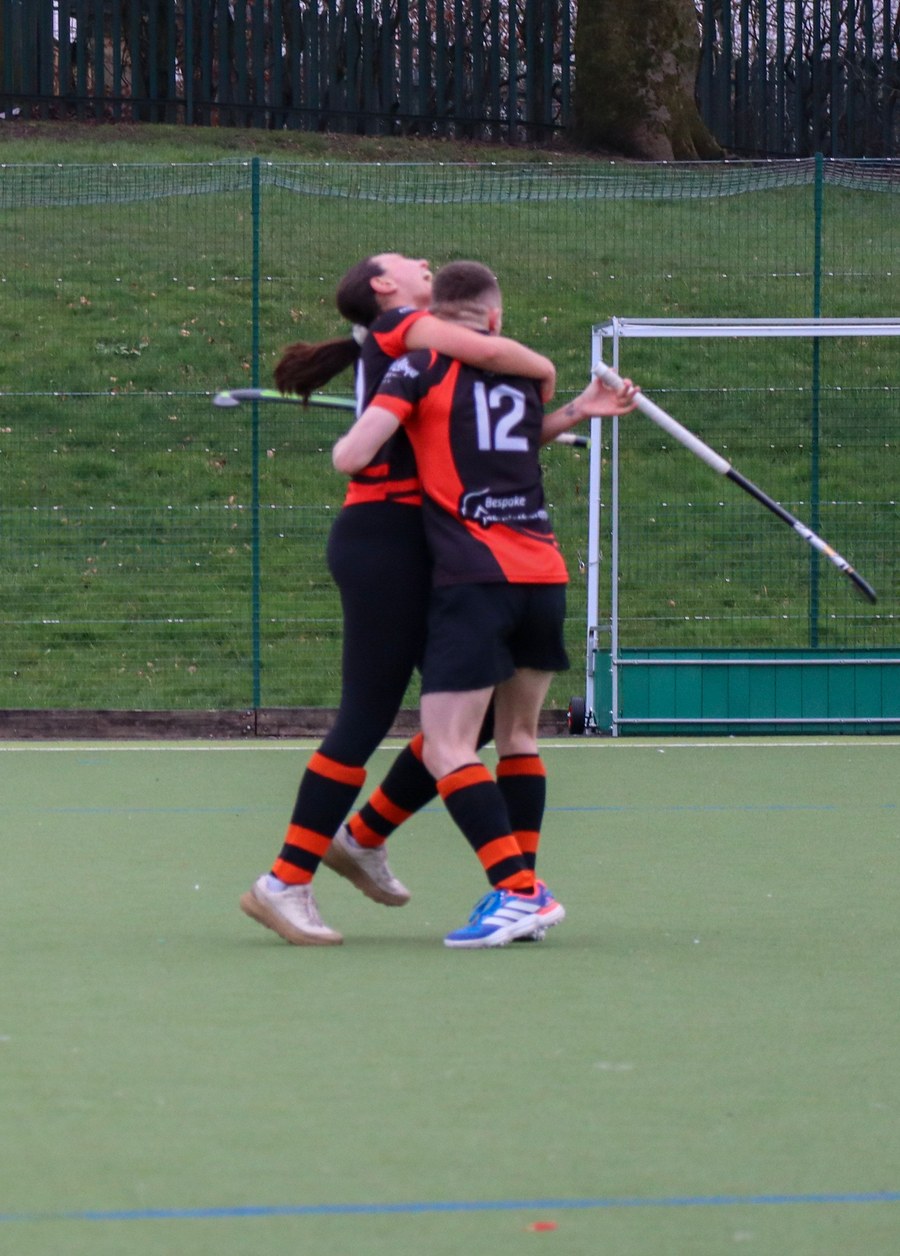 Horwich Hockey Club players celebrating on the pitch